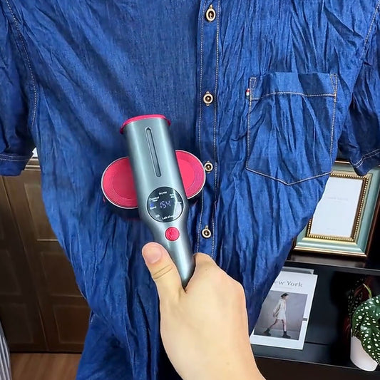 Real frame: the steamer held to a blue shirt hanging on a hanger, hands and arms only