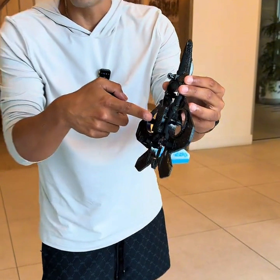 man in a white hoodie holding the jet and remote close to the camera