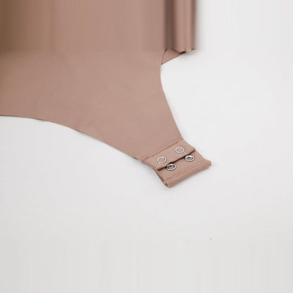 The real 2-snap closure at the bottom of the nude bodysuit, close detail