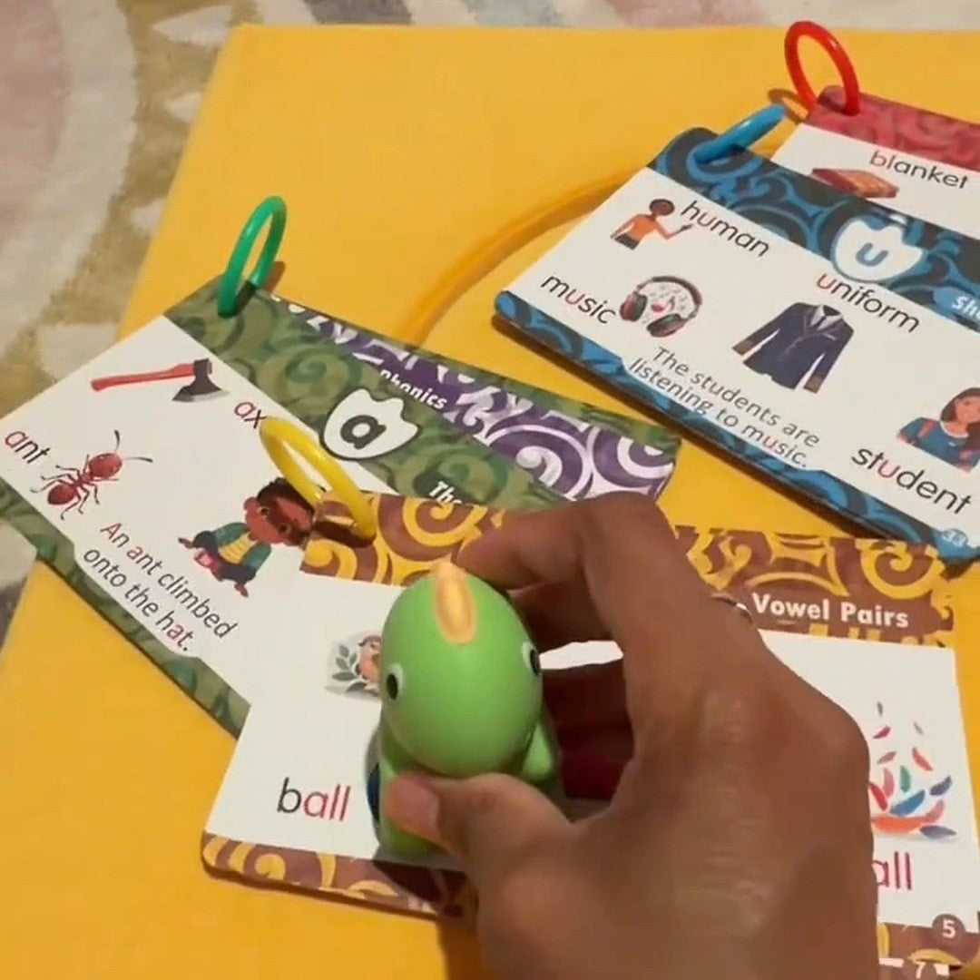 Hand pressing the green dino on a card picture
