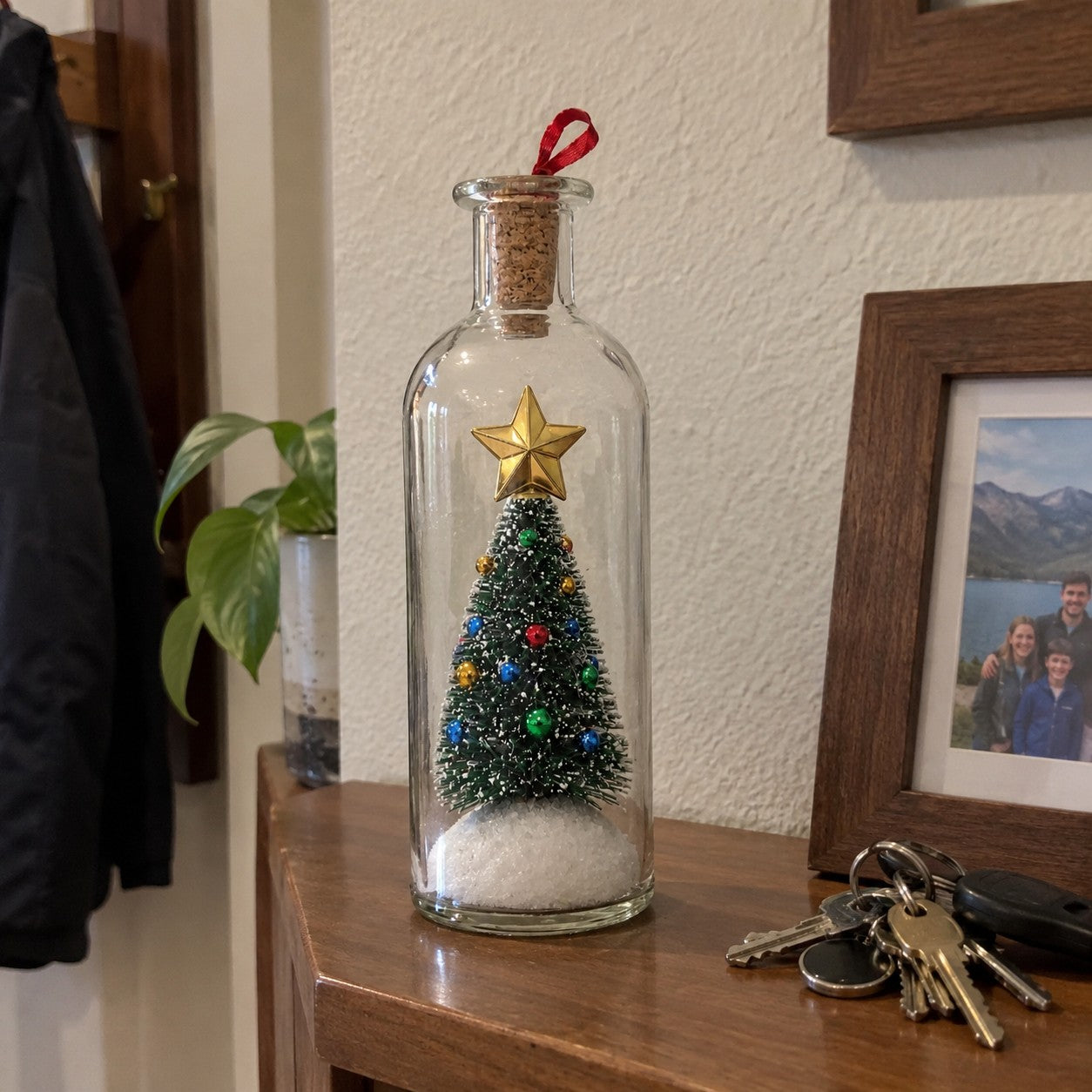 One matching bottle on a hall shelf beside keys and a framed photo