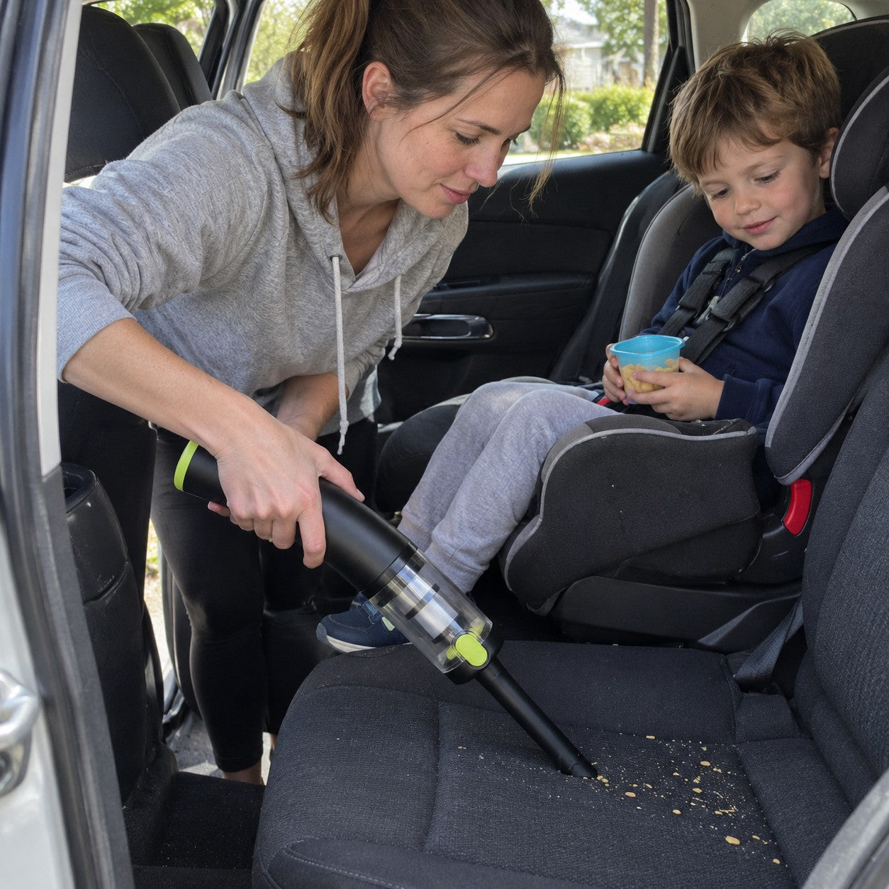 A mother and child beside the car seat