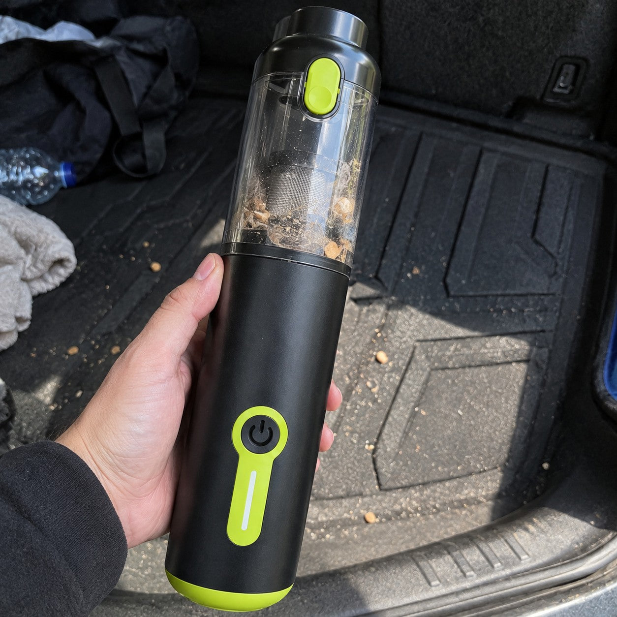 Hand holds the black and lime cylinder