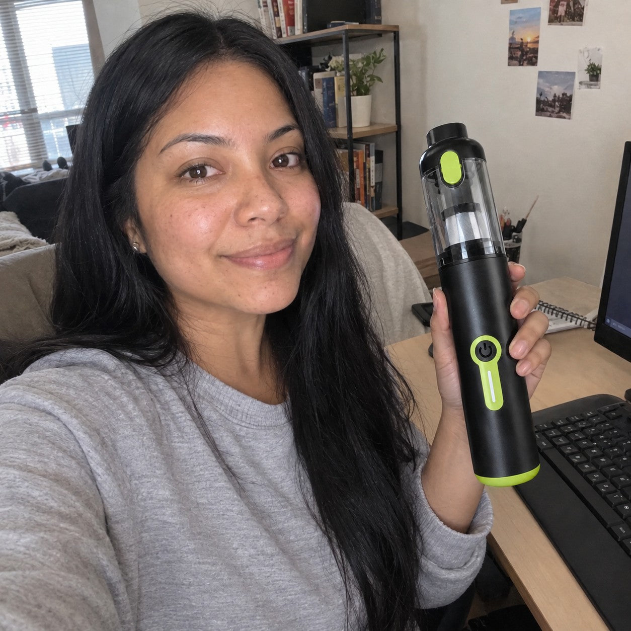 South Asian adult woman holds the correct cylindrical vacuum