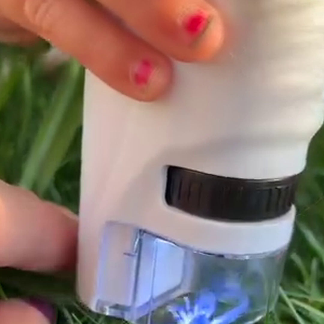 Hands hold the white microscope over checked fabric