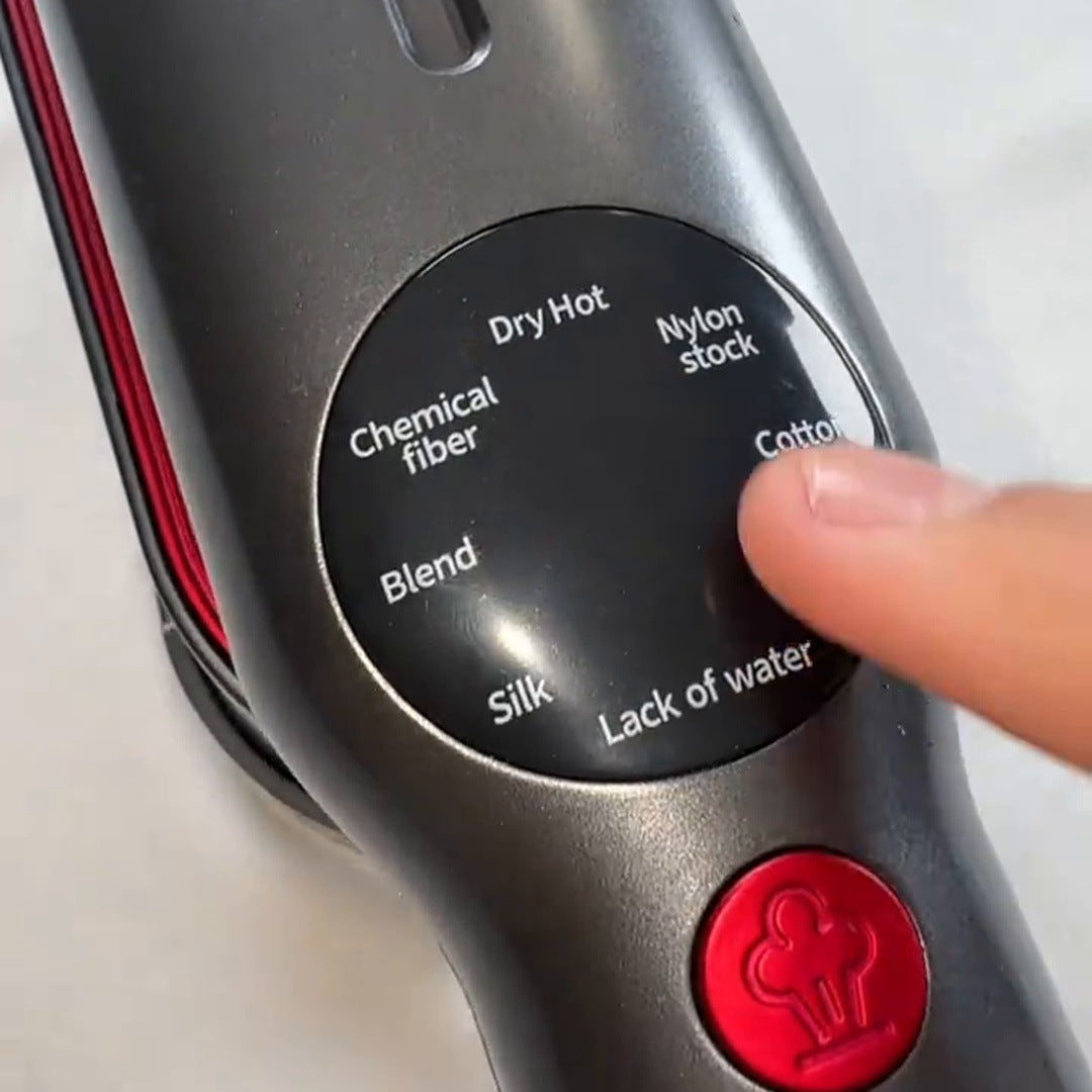Real close view of the round mode display and red steam button, with a fingertip beside the fabric mode labels