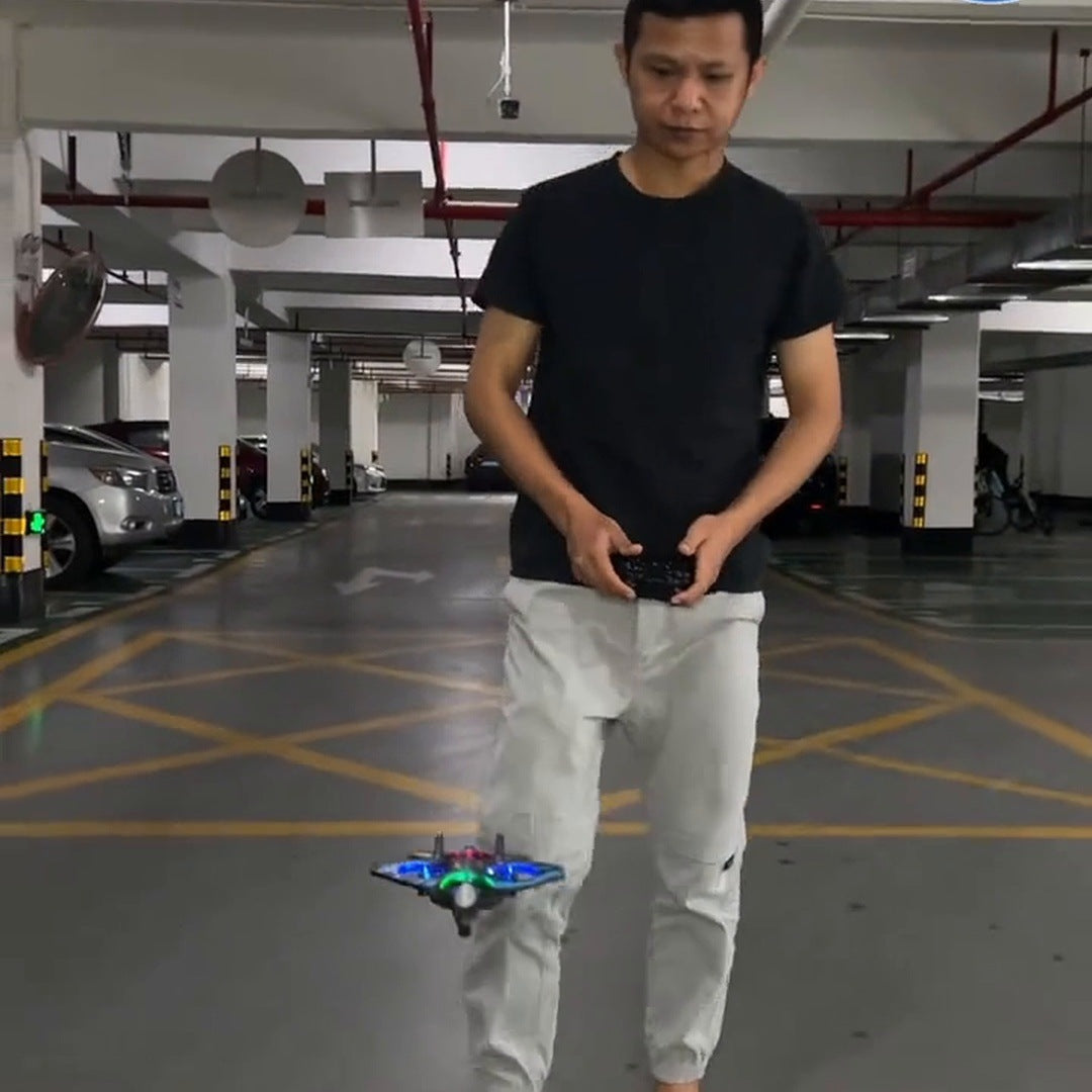 A man flying the black and blue foam jet low in a parking garage
