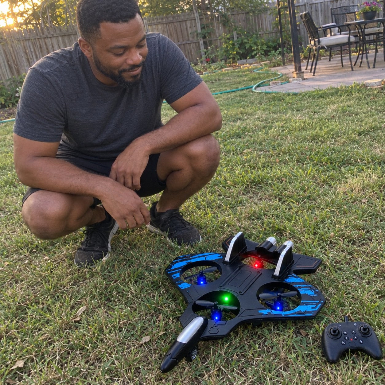 A man crouching on grass beside the jet