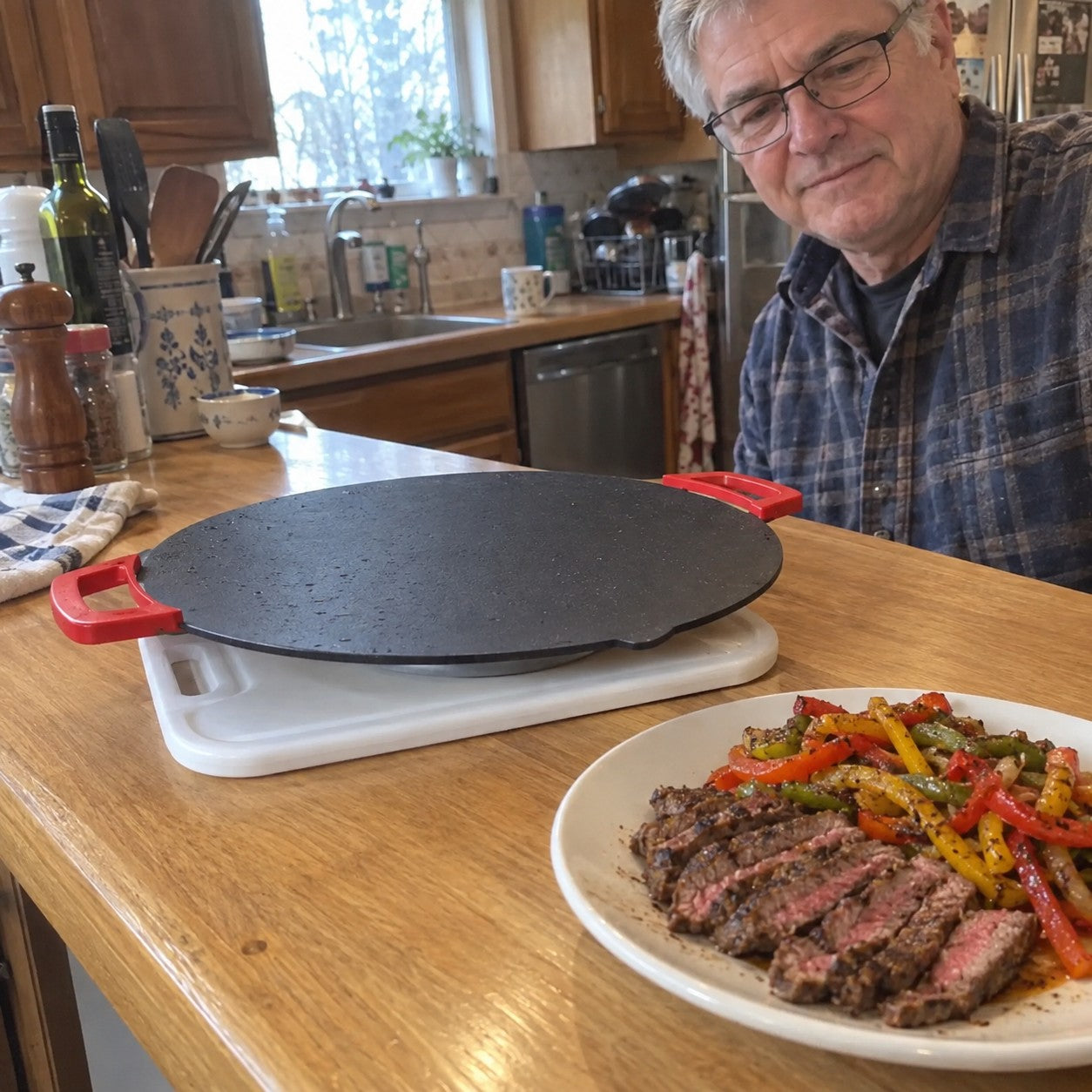 Tom H., gray hair and glasses, holds a plate of steak beside the empty grill