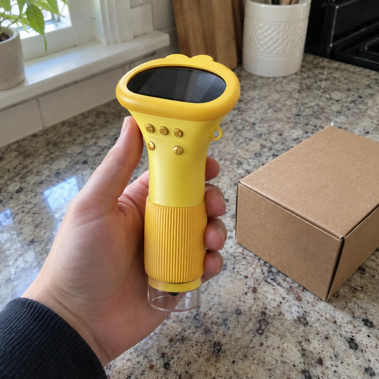 Hand holds the correct yellow scope beside a plain return box on a kitchen counter