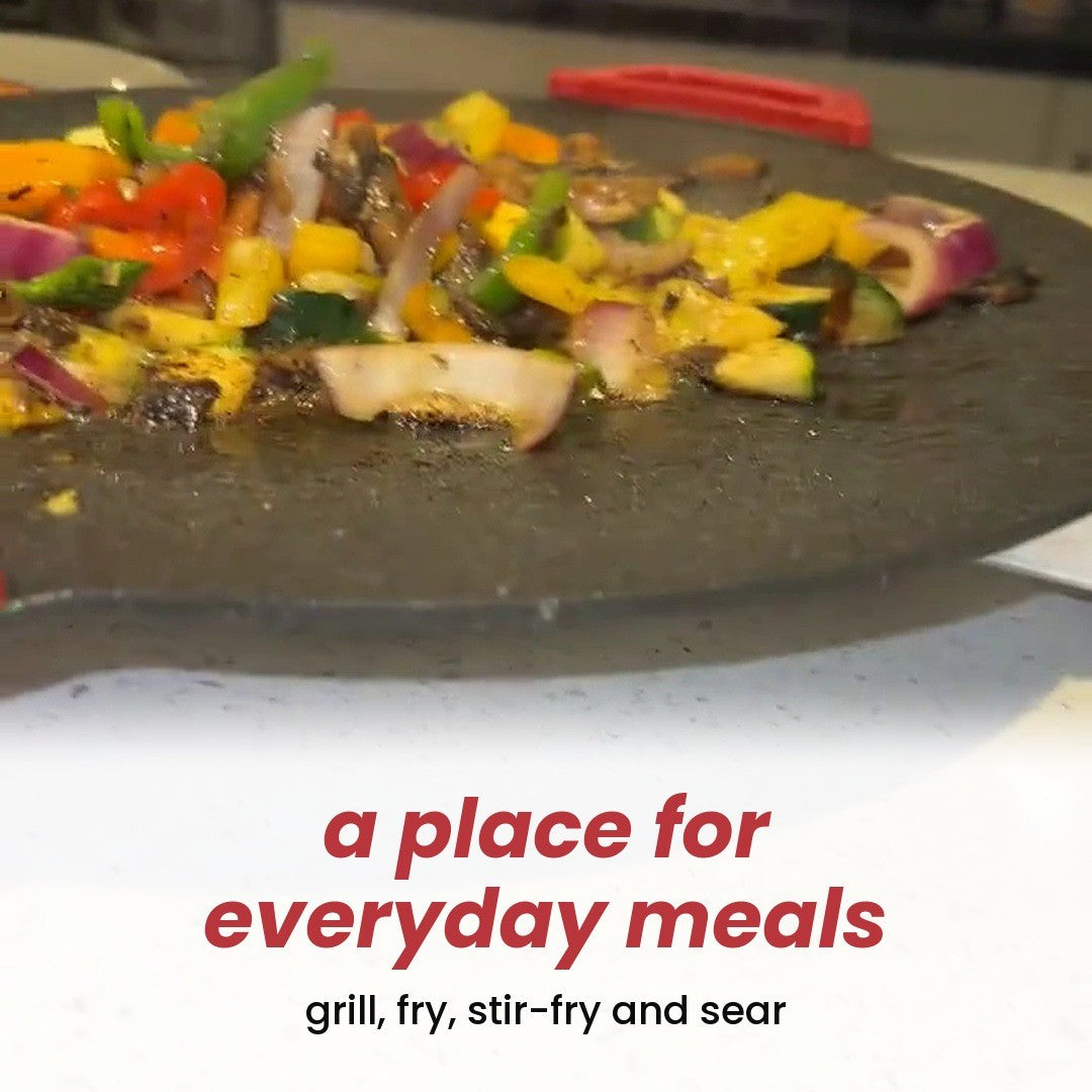 Meat and vegetables cooking on the speckled grill