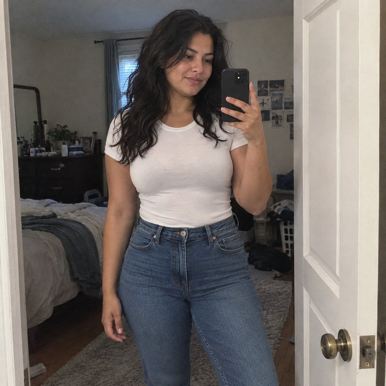 Woman in high-waist jeans and a tucked fitted tee