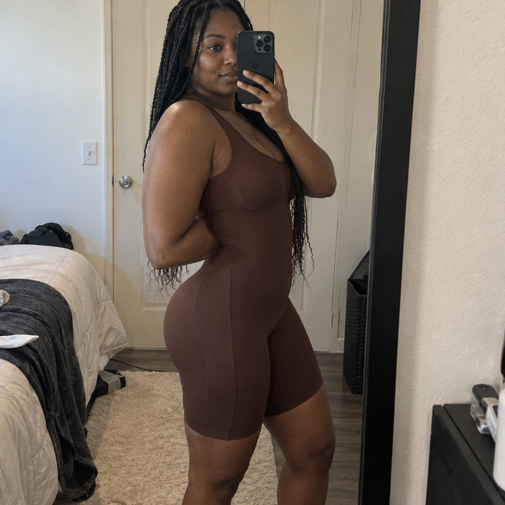 Side mirror photo of woman in brown bodysuit