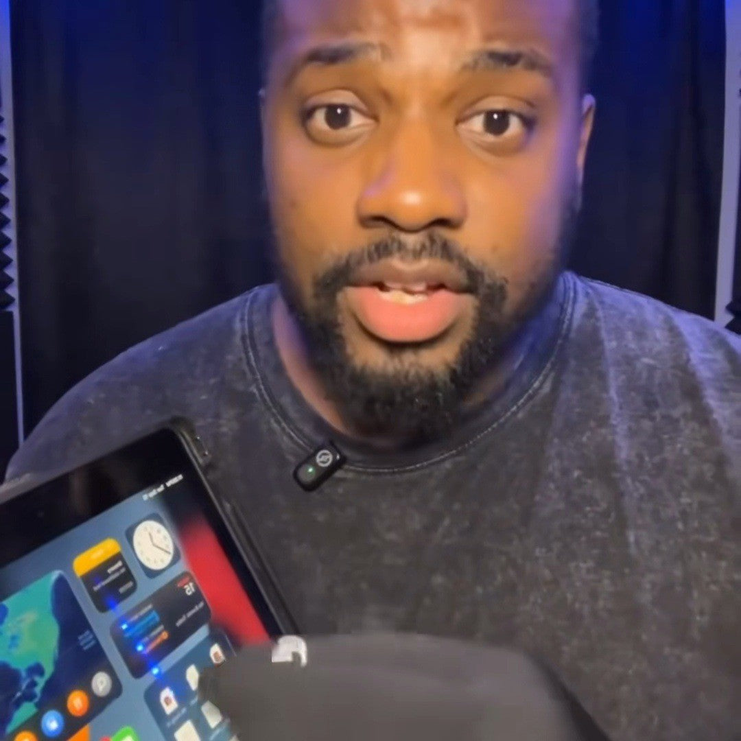 Man tapping a tablet screen with a gloved fingertip
